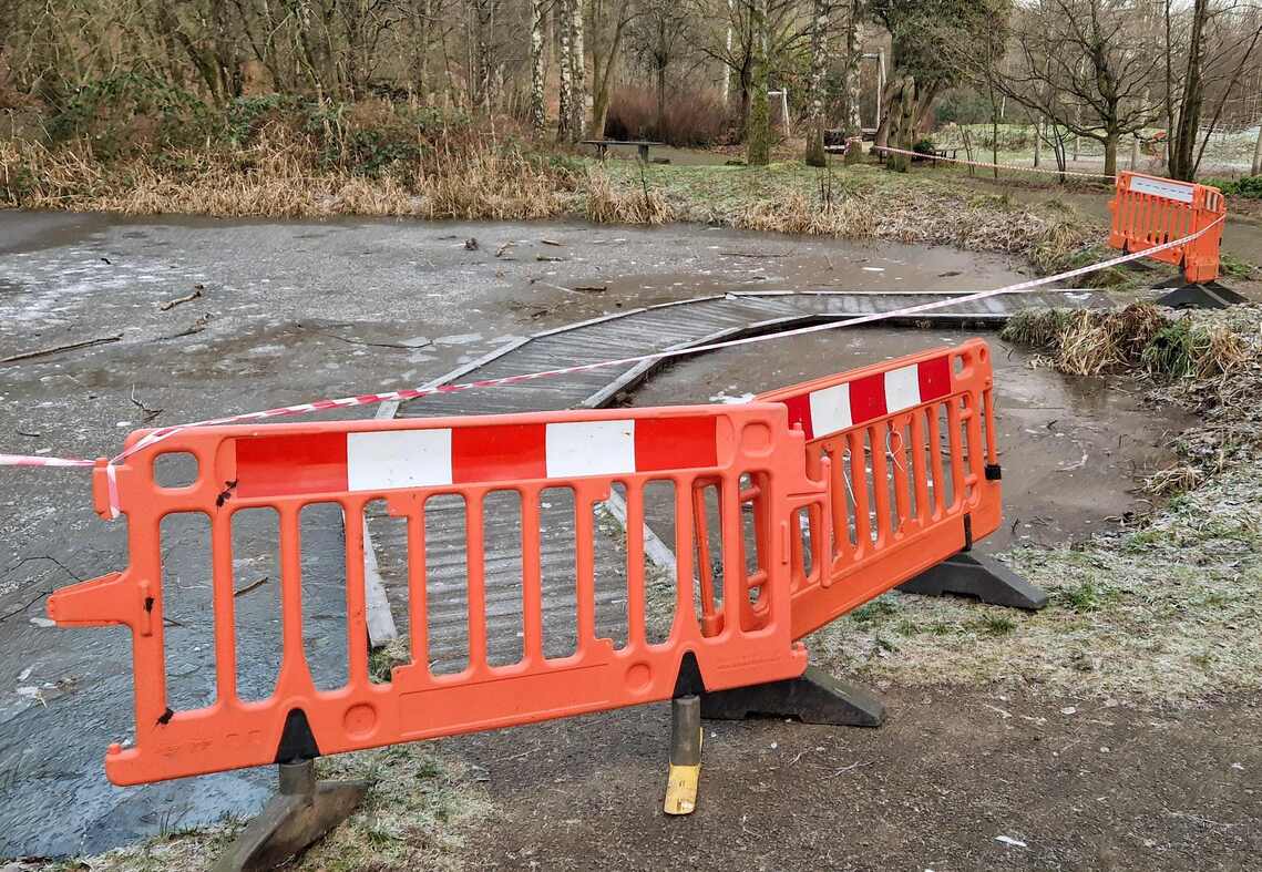 Dipping pond taped off with barriers across the walkway